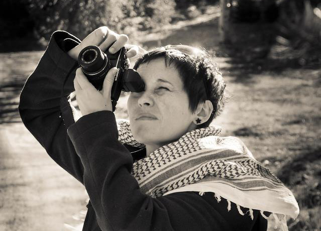 Portrait of Birmingham photographer Daniella Staub taking a photo with a camera