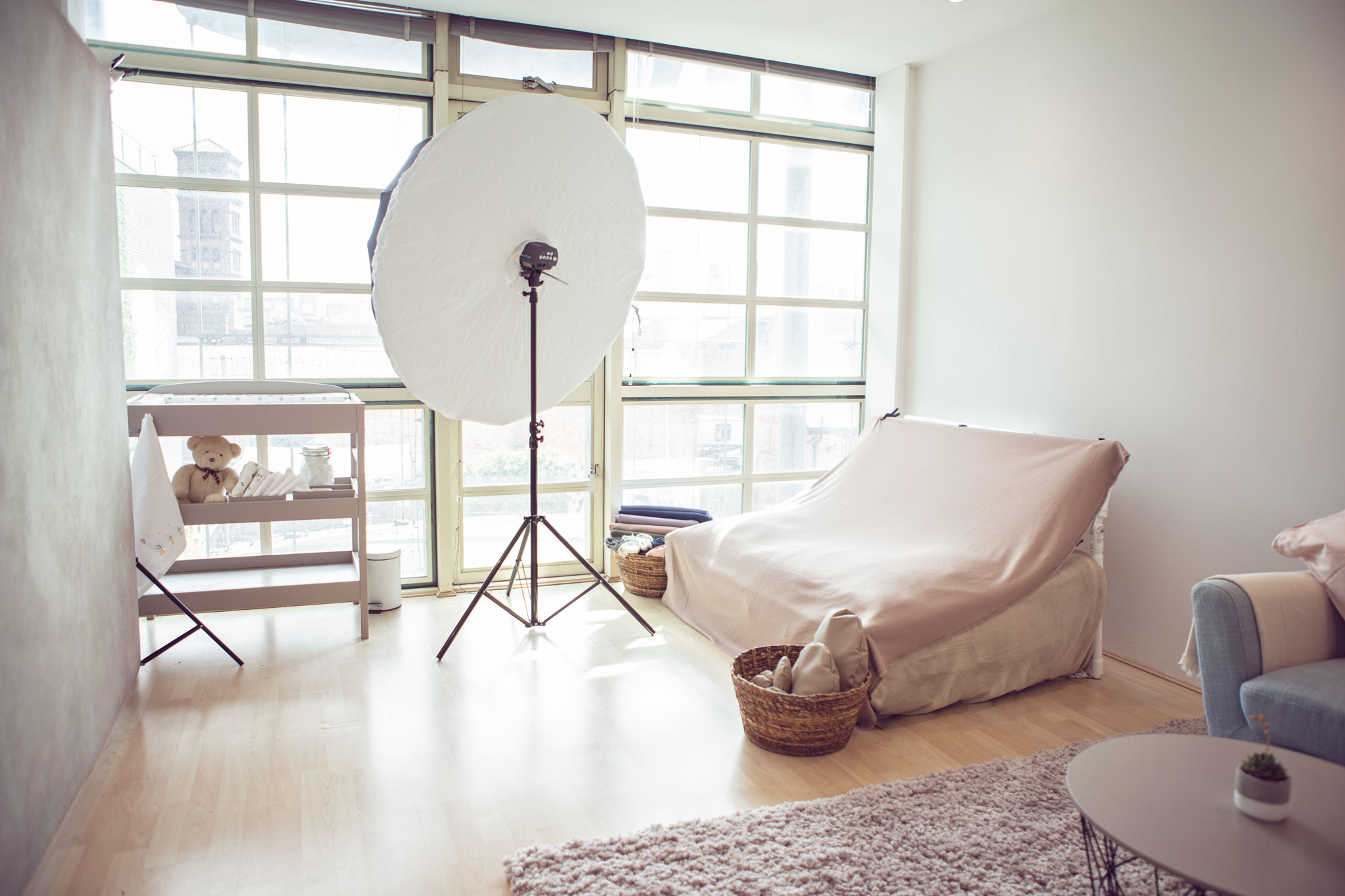 Interior of Birmingham baby photographer Daniella Staub's studio with newborn posing beanbag and light set up in pastel colours