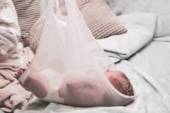 birth photography of newborn baby being weighed in a net